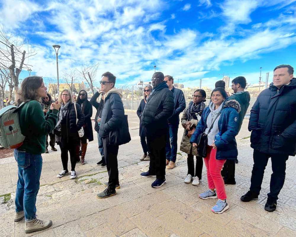 The group takes a guided walking tour in Jerusalem